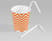 One white paper straw in a striped cup and another straw next to the cup 