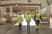 Three people walking in a warehouse.